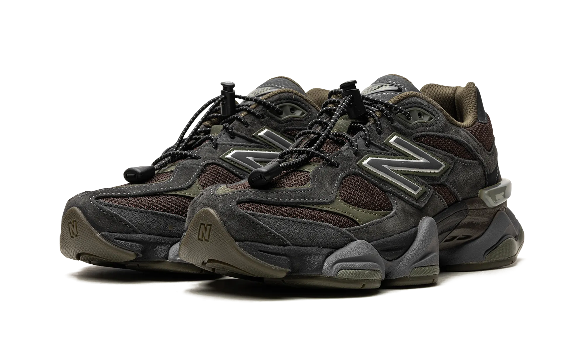 9060 "Blacktop/Dark Moss/Black" running in a roundabout area shoes