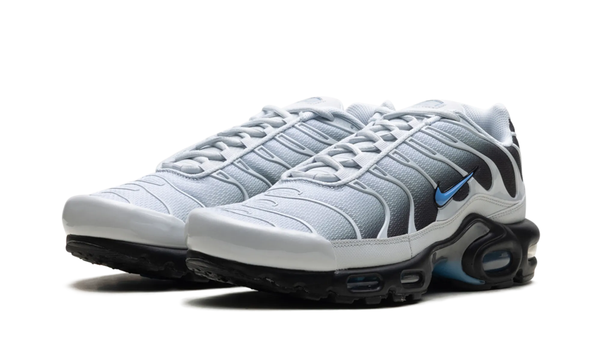 Air Max Plus "Grey University Blue Black" running in a coastal area