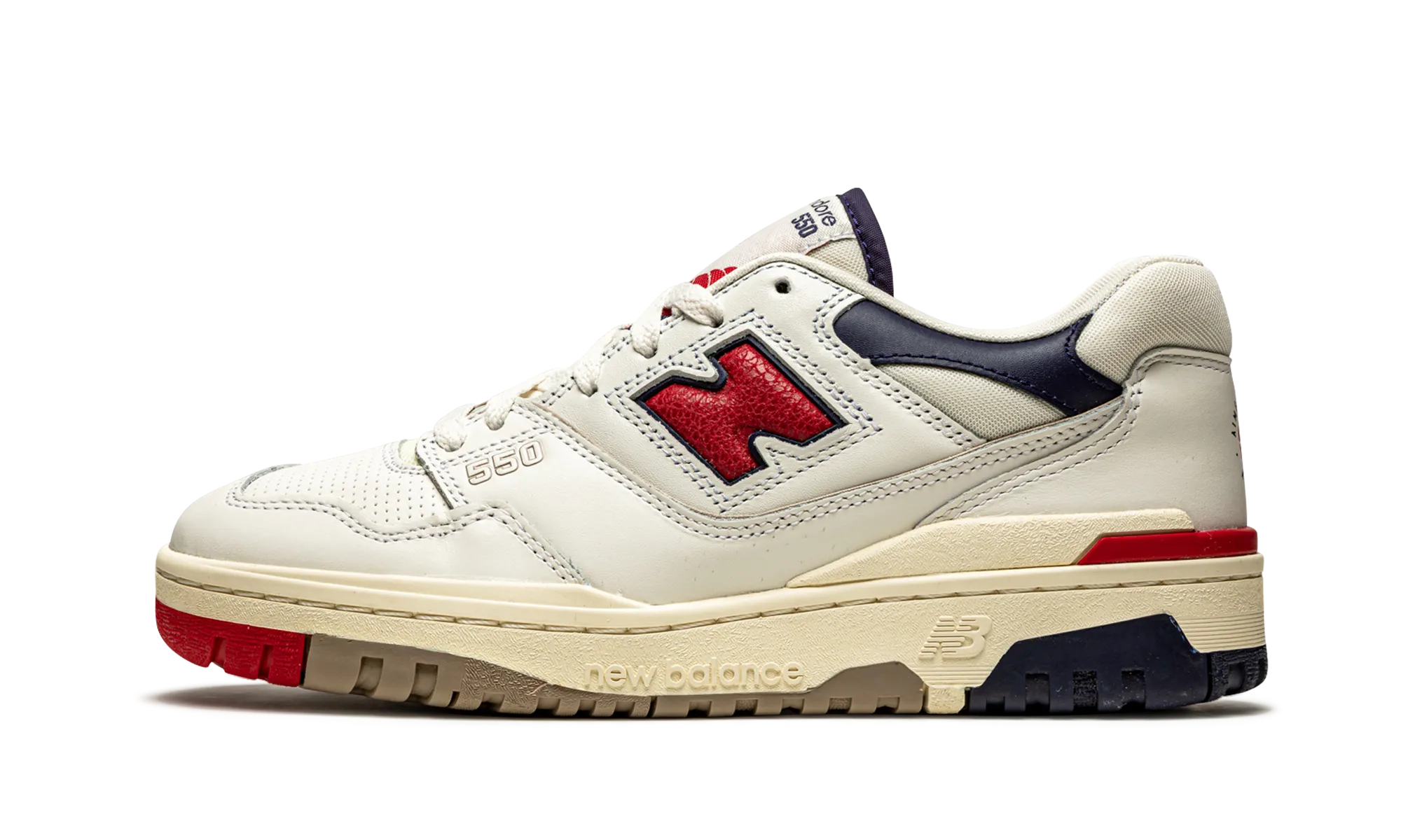 550 "Aime Leon Dore - White Navy Red" running in a tundra area